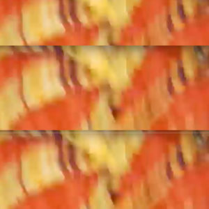 Blurry repeating abstract patterns with thick elongated orange streaks on a yellow background.