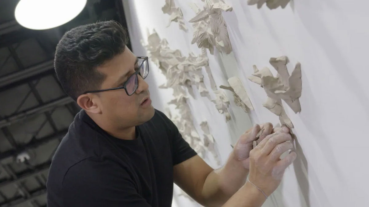 Artist Davis Salazar working on clay birds for the installation Forever (Bird Botanicals).