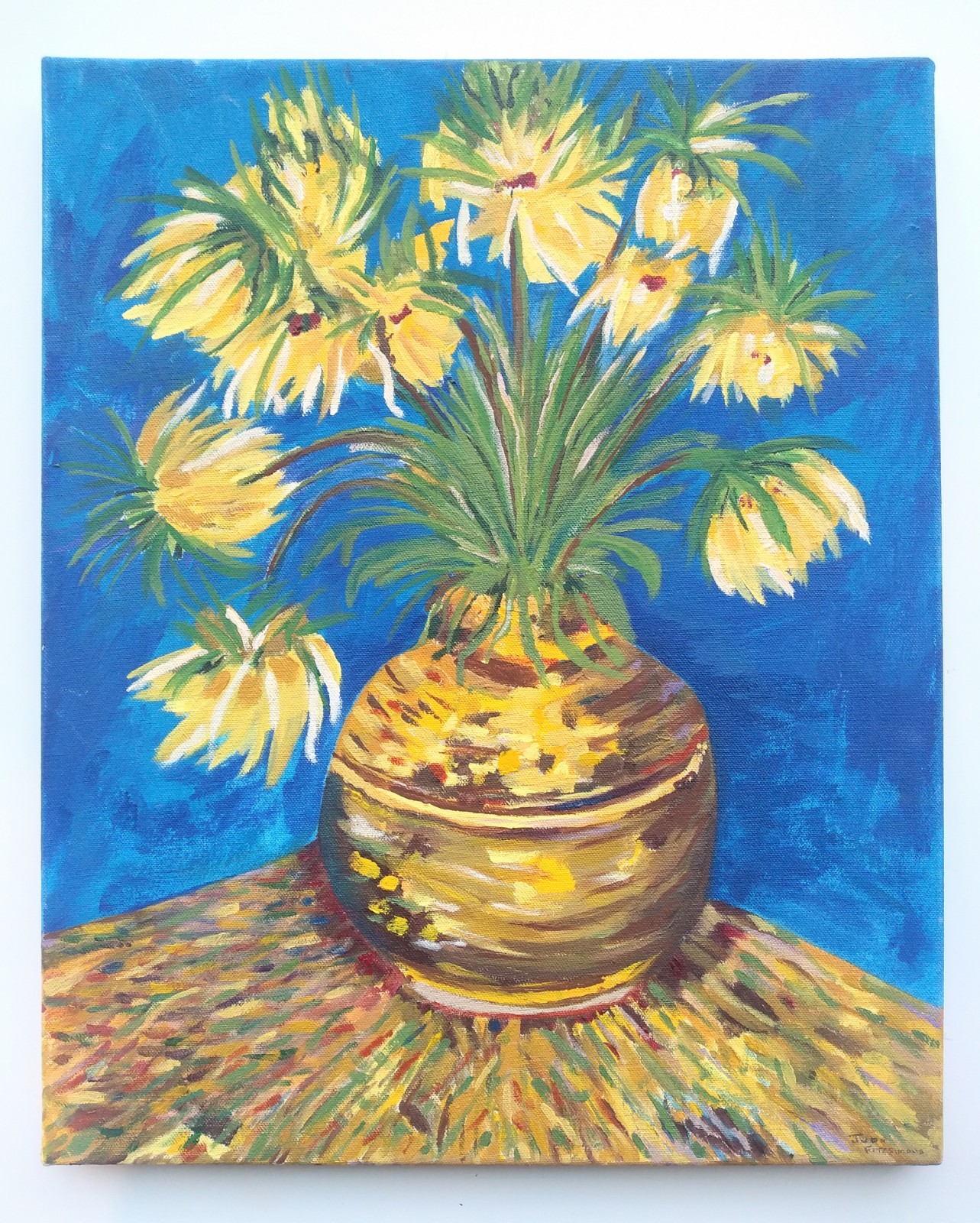 A yellow vase with yellow flowers on a corner yellow table in front of a blue background.