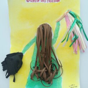 A yellow background piece with text at the top "Women Life Freedom". The back of a person in green holds pom pom per hand and brown hair. Both the pompoms and hair are 3-D.