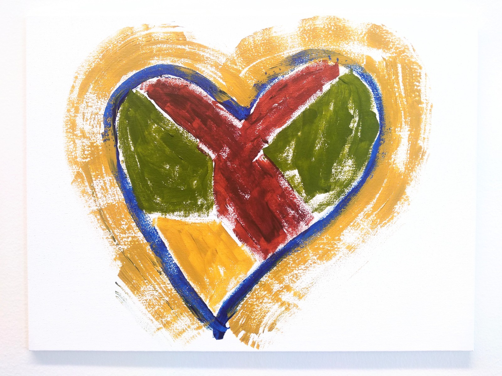A yellow bordered heart with a blue heart rim with green, red and yellow inside.