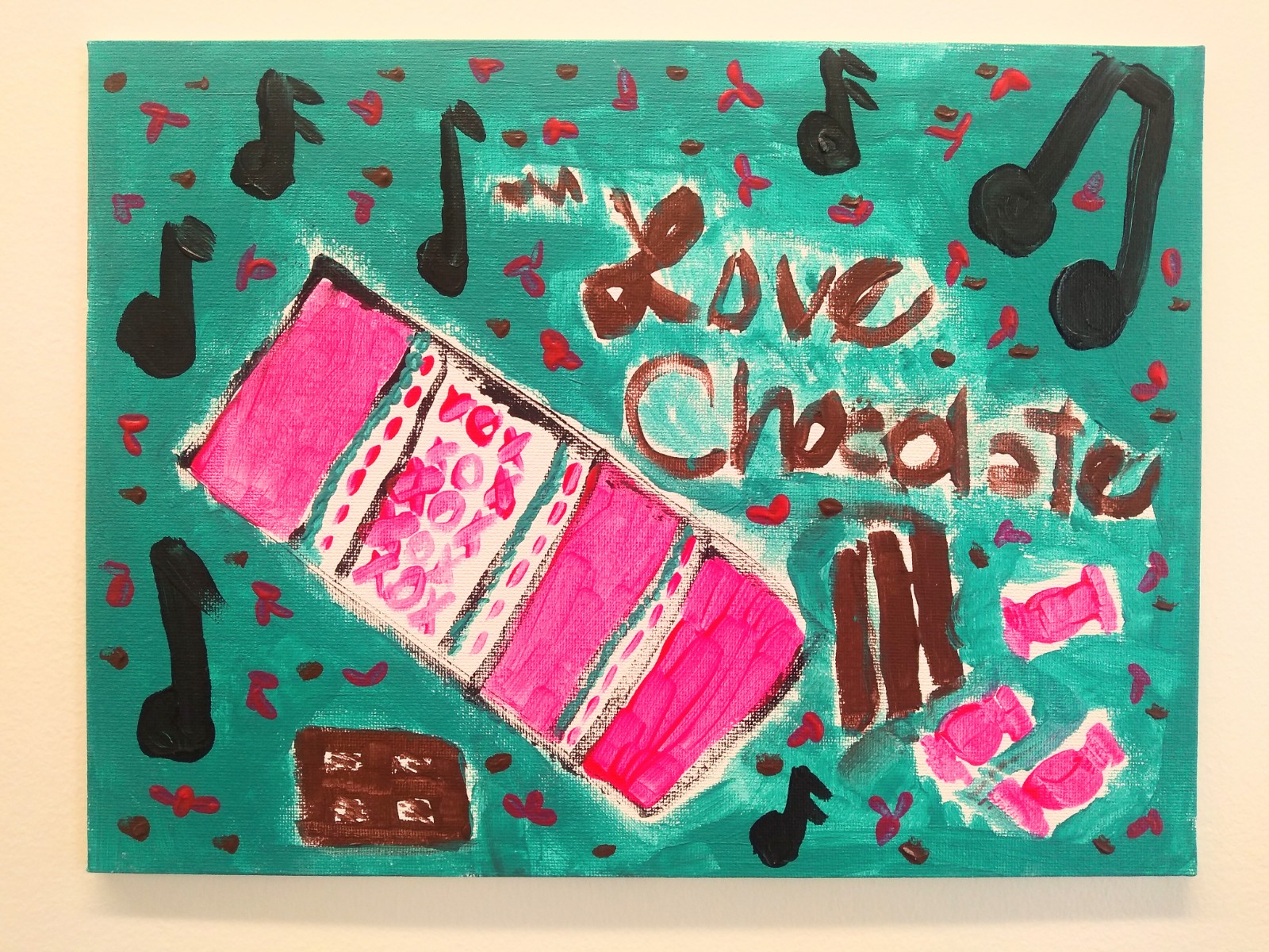 Musical notes, a pink chocolate bar and choclate pieces with text "Love Chocolate" with a teal background.