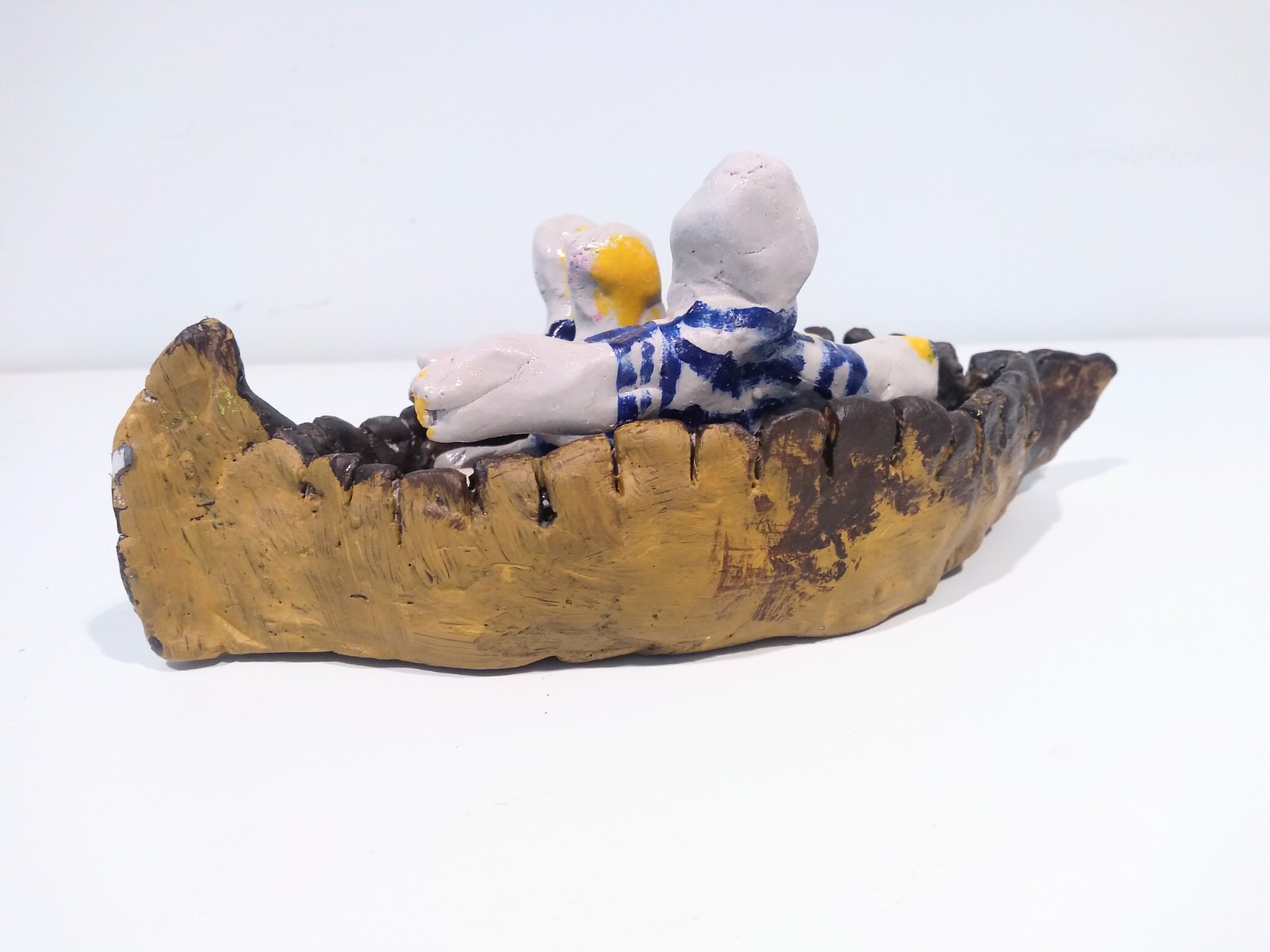 Three individuals in a boat.
