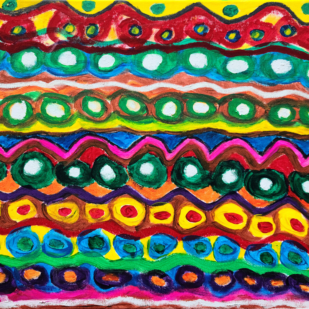 A pattern of zigzags and circles in between painted in various bright colours.