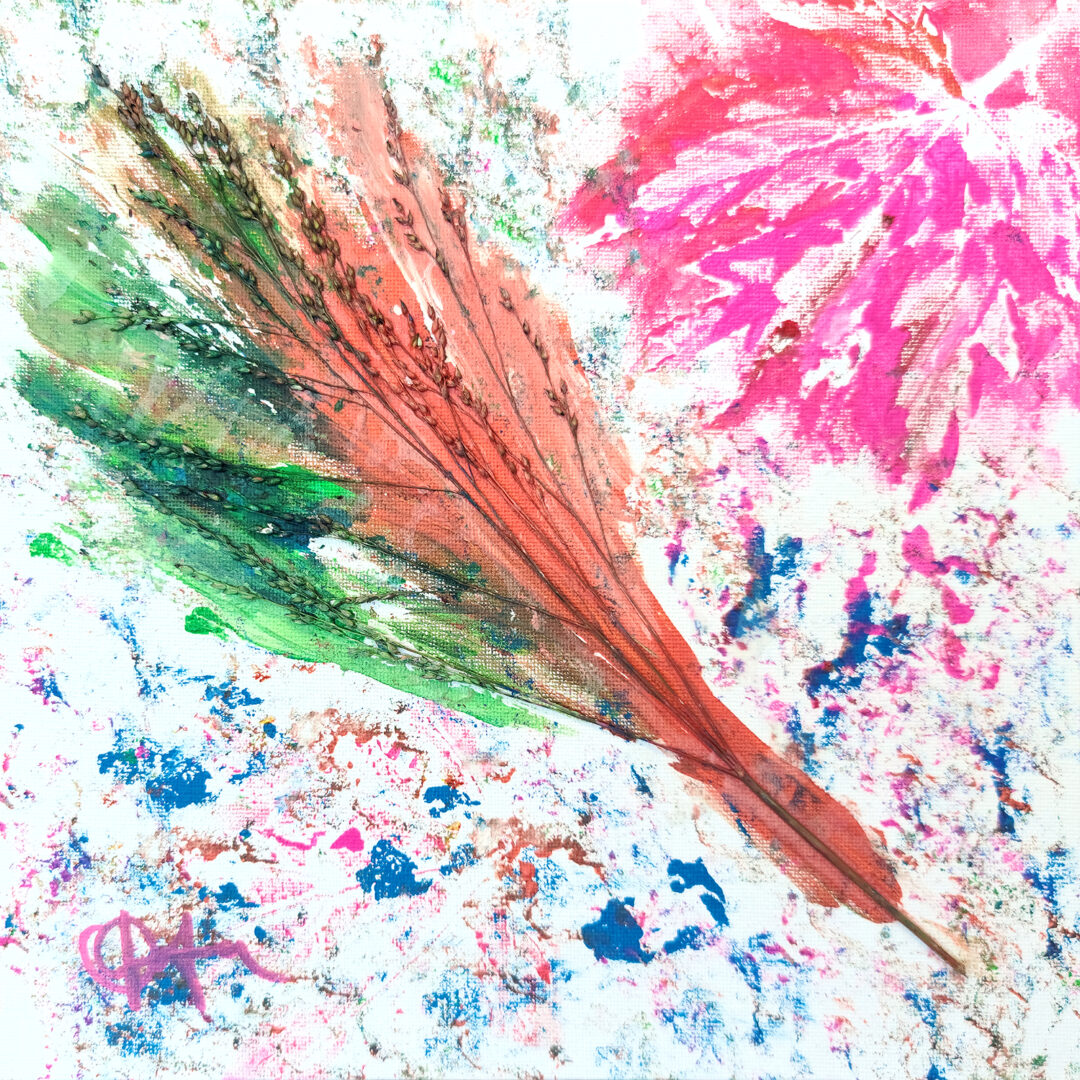 A painting with a sprig of wheat embedded in red and green paint with a pink imprint of a maple leaf in the corner.