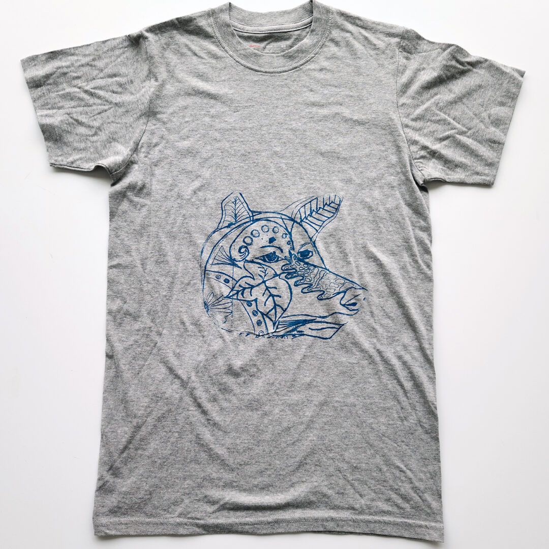 Grey t shirt screenprinted with an illustration of a dog with line art inside its face done in blue.